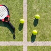 top view of paddle tennis objects on court of artificial turf, indoor sports concept and sporty lifestyle